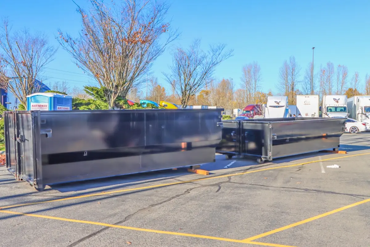 Professional dumpster rental service with roll-off container on residential driveway in North Salt Lake